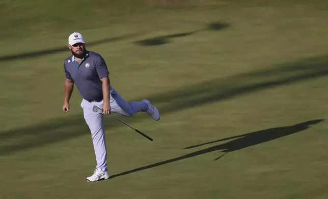 Tyrrell Hatton of England reacts top his putt on the 18th green during the third round of the British Open golf championship at the Royal Portrush Golf Club, Northern Ireland, Saturday, July 19, 2025. (AP Photo/Peter Morrison)