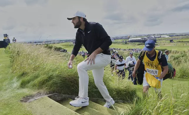 Scottie Scheffler of the United States walks to the 3rd tee during the third round of the British Open golf championship at the Royal Portrush Golf Club, Northern Ireland, Saturday, July 19, 2025. (AP Photo/Jon Super)