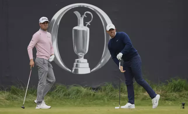Rory McIlroy of Northern Ireland, right and Justin Thomas of the United States on the 1st tee during the second round of the British Open golf championship at the Royal Portrush Golf Club, Northern Ireland, Friday, July 18, 2025. (AP Photo/Peter Morrison)