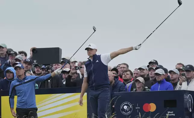 Ludvig Aberg of Sweden, right, and Viktor Hovland of Norway gesture that a ball has been hit left off the 14th tee during the first round of the British Open golf championship at the Royal Portrush Golf Club, Northern Ireland, Thursday, July 17, 2025. (AP Photo/Jon Super)