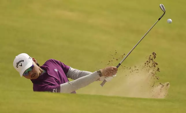 Min Woo Lee of Australia plays out of a bunker on the 8th hole during the second round of the British Open golf championship at the Royal Portrush Golf Club, Northern Ireland, Friday, July 18, 2025. (AP Photo/Francisco Seco)