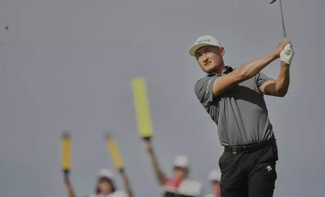 Li Haotong of China plays his shot on the 6th tee during the third round of the British Open golf championship at the Royal Portrush Golf Club, Northern Ireland, Saturday, July 19, 2025. (AP Photo/Francisco Seco)