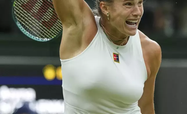 Aryna Sabalenka of Belarus returns to Belgium's Elise Mertens during a fourth round women's singles match at the Wimbledon Tennis Championships in London, Sunday, July 6, 2025. (AP Photo/Alastair Grant)