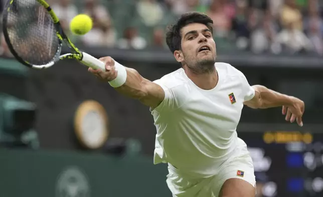Spain's Carlos Alcaraz returns to Russia's Andrey Rublev during a fourth round men's singles match at the Wimbledon Tennis Championships in London, Sunday, July 6, 2025. (AP Photo/Alastair Grant)