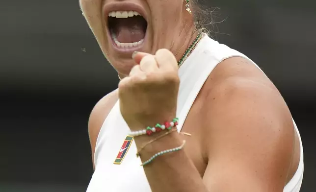 Aryna Sabalenka of Belarus reacts after winning a point against Belgium's Elise Mertens during a fourth round women's singles match at the Wimbledon Tennis Championships in London, Sunday, July 6, 2025. (AP Photo/Alastair Grant)