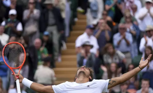 Flavio Cobolli of Italy celebrates winning his men's singles fourth round match against Marin Cilic of Croatia at the Wimbledon Tennis Championships in London, Monday, July 7, 2025.(AP Photo/Joanna Chan)