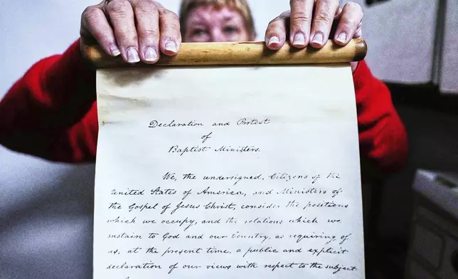 Historian Jennifer Cromack holds a recently found, 178-year-old anti-slavery scroll at Grotonwood, the home mission of The American Baptist Churches of Massachusetts, Thursday, June 26, 2025, in Groton, Mass. (AP Photo/Charles Krupa)