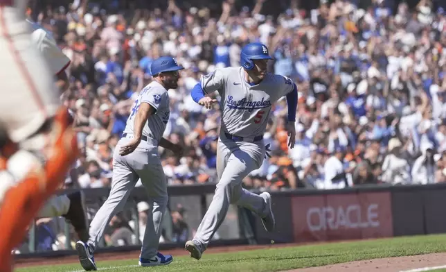 Los Angeles Dodgers' Freddie Freeman (5) runs home to score against the San Francisco Giants during the 11th inning of a baseball game in San Francisco, Sunday, July 13, 2025. (AP Photo/Jeff Chiu)