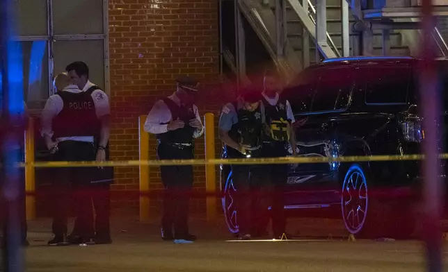Chicago police investigate the scene of a shooting that took place at Artis Restaurant and Lounge located Chicago Avenue in the River North neighborhood, Thursday, July 3, 2025. (Tyler Pasciak LaRiviere/Chicago Sun-Times via AP)