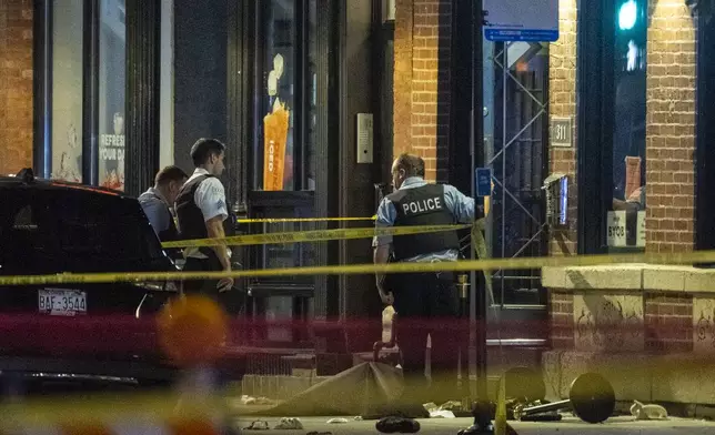 Chicago police investigate the scene of a shooting that took place at Artis Restaurant and Lounge located on Chicago Avenue in the River North neighborhood, Thursday, July 3, 2025. (Tyler Pasciak LaRiviere/Chicago Sun-Times via AP)