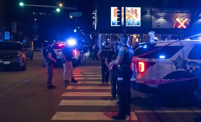 Chicago police investigate the scene of a shooting that took place at Artis Restaurant and Lounge located on Chicago Avenue in the River North neighborhood, Thursday, July 3, 2025. (Tyler Pasciak LaRiviere/Chicago Sun-Times via AP)