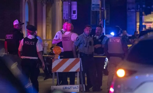Chicago police investigate the scene of a shooting that took place at Artis Restaurant and Lounge located Chicago Avenue in the River North neighborhood, Thursday, July 3, 2025. (Tyler Pasciak LaRiviere/Chicago Sun-Times via AP)