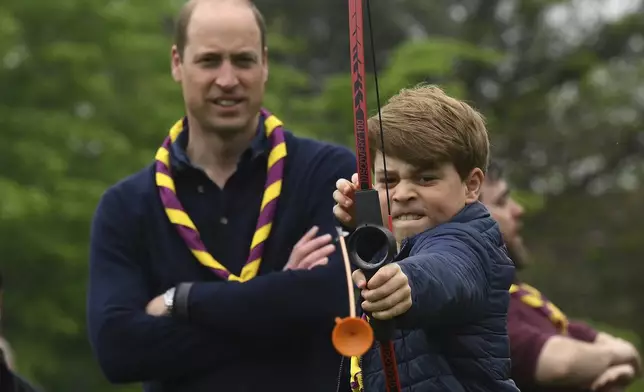 Britain's Prince George tries his hand at archery while taking part in the Big Help Out, during a visit to the 3rd Upton Scouts Hut in Slough, England, May 8, 2023. (Daniel Leal/Pool Photo via AP, File)