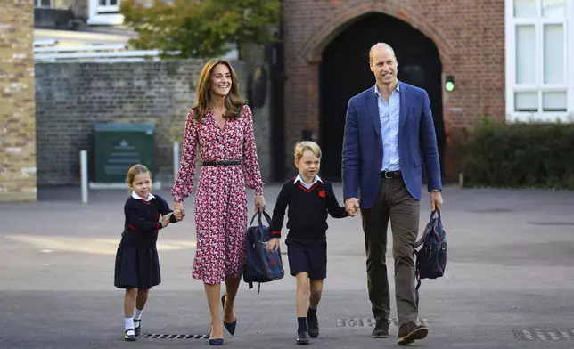 Britain's Princess Charlotte, left, with her brother Prince George and their parents Prince William and Kate, Duchess of Cambridge, arrive for her first day of school at Thomas's Battersea in London, Sept. 5, 2019. (Aaron Chown/Pool via AP, File)