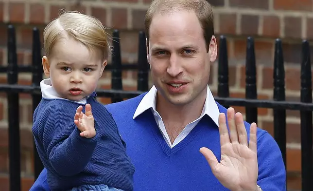 Britain's Prince William and his son Prince George wave as they return to St. Mary's Hospital's exclusive Lindo Wing, London, May 2, 2015, after William's wife, Kate, the Duchess of Cambridge, gave birth to a baby girl. (AP Photo/Kirsty Wigglesworth, File)