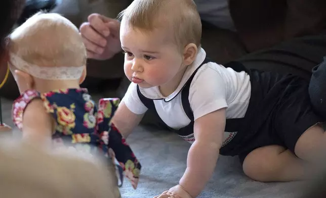 Britain's Prince George, right, plays during a visit to Plunket nurse and parents group at Government House in Wellington, New Zealand, April 9, 2014. (Marty Melville, Pool Photo via AP, file)