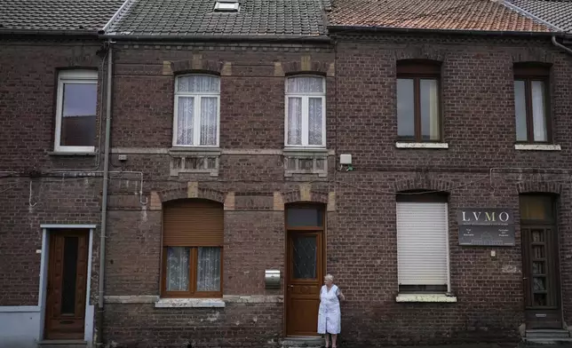 A woman stands on the side of the road during the third stage of the Tour de France cycling race over 178.3 kilometers (110.8 miles) with start in Valenciennes and finish in Dunkerque, France, Monday, July 7, 2025. (AP Photo/Mosa'ab Elshamy)