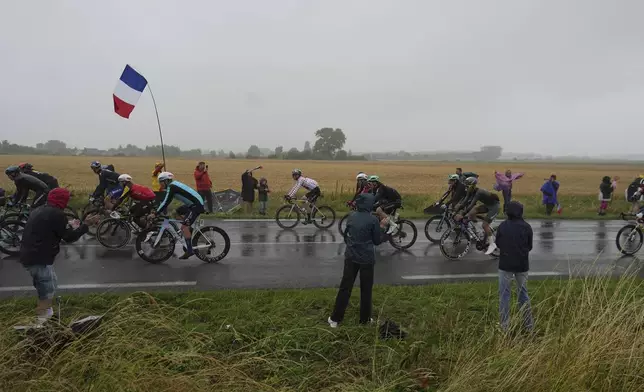 Spectators cheer the riders during the second stage of the Tour de France cycling race over 209.1 kilometers (129.9 miles) with start in Lauwin-Planque and finish in Boulogne-sur-Mer, France, Sunday, July 6, 2025. (AP Photo/Thibault Camus)