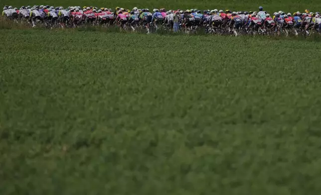 The pack rides during the third stage of the Tour de France cycling race over 178.3 kilometers (110.8 miles) with start in Valenciennes and finish in Dunkerque, France, Monday, July 7, 2025. (AP Photo/Mosa'ab Elshamy)
