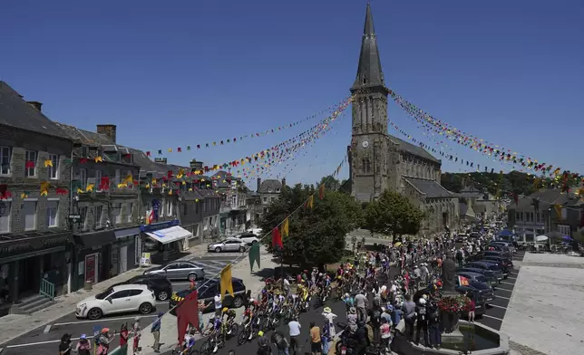 The pack crosses Athis-de-L'orne during the sixth stage of the Tour de France cycling race over 201.5 kilometers (125.2 miles) with start in Bayeux and finish in Vire Normandy, France, Thursday, July 10, 2025. (AP Photo/Thibault Camus)