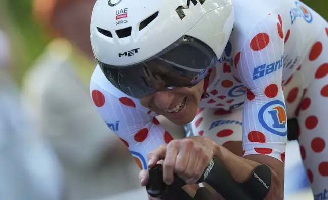 Slovenia's Tadej Pogacar wearing the best climber's dotted jersey crosses the finish line during the fifth stage of the Tour de France cycling race, an indivdual time-trial over 33 kilometers (20.5 miles) with start and finish in Caen, France, Wednesday, July 9, 2025. (AP Photo/Thibault Camus)