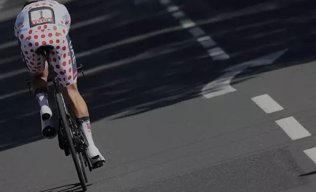 Slovenia's Tadej Pogacar wearing the best climber's dotted jersey competes during the fifth stage of the Tour de France cycling race, an indivdual time-trial over 33 kilometers (20.5 miles) with start and finish in Caen, France, Wednesday, July 9, 2025. (AP Photo/Mosa'ab Elshamy)