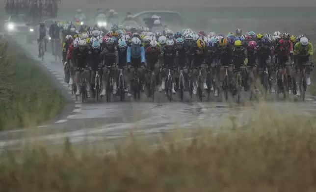 The pack rides during the second stage of the Tour de France cycling race over 209.1 kilometers (129.9 miles) with start in Lauwin-Planque and finish in Boulogne-sur-Mer, France, Sunday, July 6, 2025. (AP Photo/Thibault Camus)
