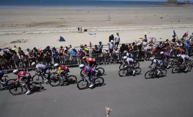 The pack rides along the beach during the seventh stage of the Tour de France cycling race over 197 kilometers (122.4 miles) with start in Saint-Malo and finish in Mur-de-Bretagne Guerledan, France, Friday, July 11, 2025. (AP Photo/Mosa'ab Elshamy)