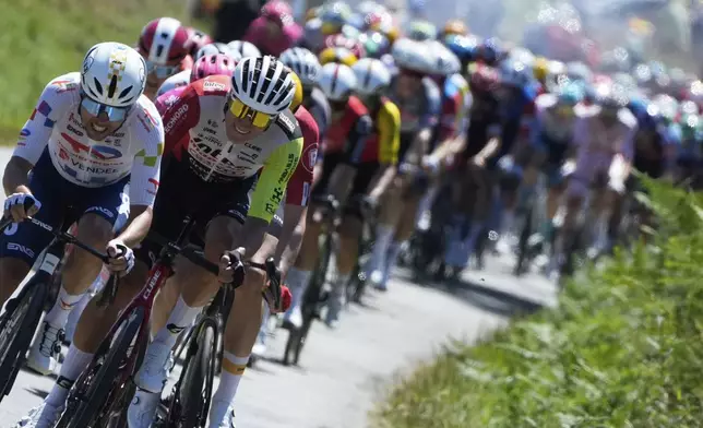 The pack rides during the seventh stage of the Tour de France cycling race over 197 kilometers (122.4 miles) with start in Saint-Malo and finish in Mur-de-Bretagne Guerledan, France, Friday, July 11, 2025. (AP Photo/Mosa'ab Elshamy)