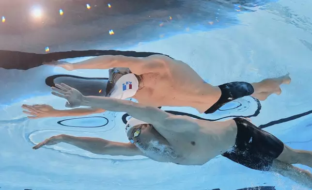 Leon Marchand of France competes in the men's 200-meter individual medley final at the World Aquatics Championships in Singapore, Thursday, July 31, 2025. (AP Photo/Lee Jin-man)
