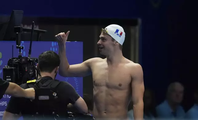 Leon Marchand of France celebrates after winning gold medal in the men's 200-meter individual medley final at the World Aquatics Championships in Singapore, Thursday, July 31, 2025. (AP Photo/Vincent Thian)
