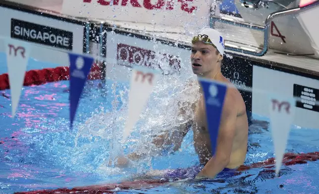 Leon Marchand of France reacts after competing in the men's 200-meter individual medley semifinals at the World Aquatics Championships in Singapore, Wednesday, July 30, 2025. (AP Photo/Lee Jin-man)
