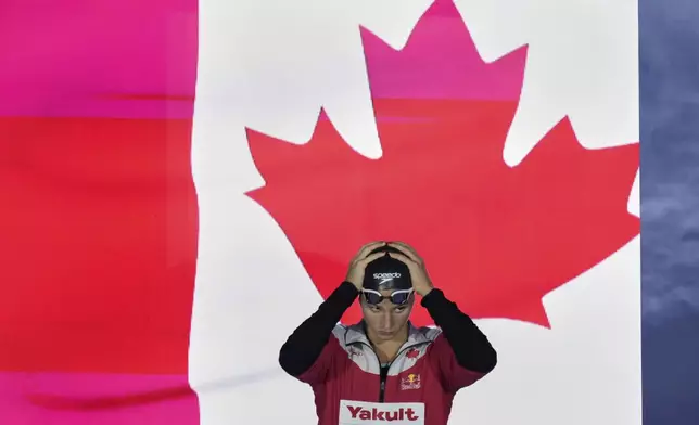 Summer Mcintosh of Canada arrives to compete in the women's 200-meter butterfly semifinals at the World Aquatics Championships in Singapore, Wednesday, July 30, 2025. (AP Photo/Lee Jin-man)