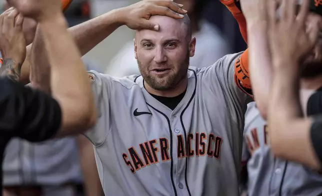 San Francisco Giants' Casey Schmitt (10) celebrates his solo home run against the Atlanta Braves in the second inning of a baseball game, Tuesday, July 22, 2025, in Atlanta. (AP Photo/Mike Stewart)