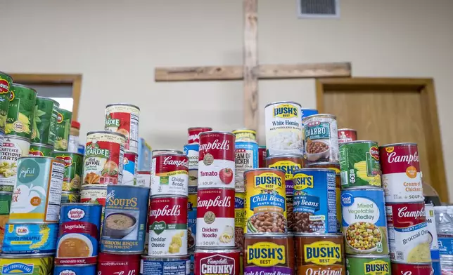 Cans of food and other donations are ready for distribution at the Hunt Baptist Church, following extreme flooding along the Guadalupe River, Sunday, July 6, 2025, in Hunt, Texas. (AP Photo/Rodolfo Gonzalez)
