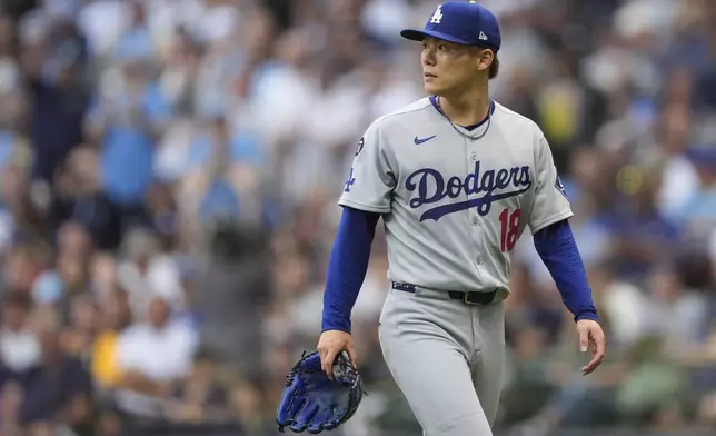 Los Angeles Dodgers' Yoshinobu Yamamoto looks on after being taken out during the first inning of a baseball game against the Milwaukee Brewers, Monday, July 7, 2025, in Milwaukee. (AP Photo/Aaron Gash)
