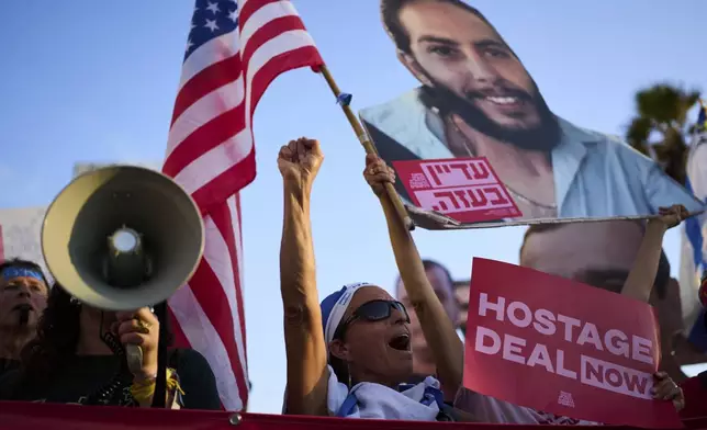 People attend a rally calling for the release of hostages held in the Gaza Strip and urges a ceasefire, in front of the U.S. Embassy branch office in Tel Aviv, Israel, Monday, July 7, 2025, ahead of the planned meeting between U.S. President Donald Trump and Israeli Prime Minister Benjamin Netanyahu. (AP Photo/Oded Balilty)
