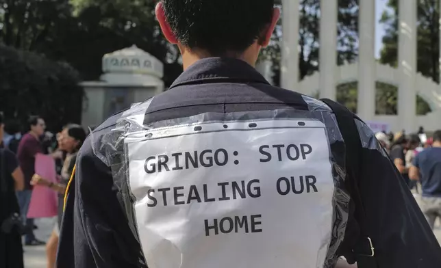 People protest against Americans' gentrification of parts of Mexico City, at Parque Mexico, Friday, July 4, 2025. (AP Photo/Jon Orbach)
