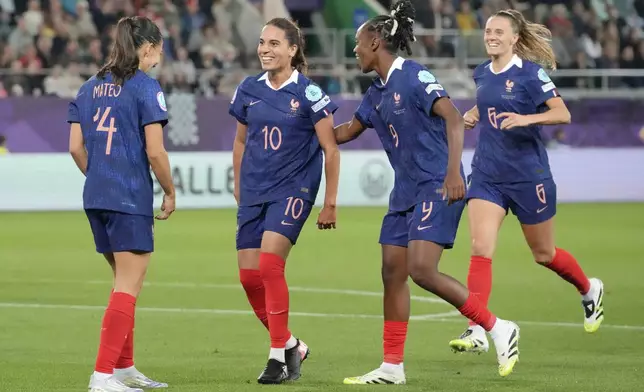 France's Amel Majri, 2nd left, celebrates with teammates after scoring her sides third goal during the Euro 2025, group D, soccer match between France and Wales at Arena St. Gallen in St. Gallen, Switzerland, Wednesday, July 9, 2025. (AP Photo/Martin Meissner)