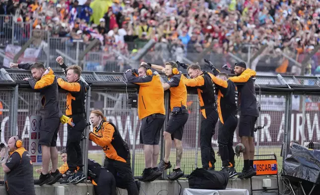Team members cheer for McLaren driver Lando Norris of Britain as he wins the British Formula One Grand Prix race at the Silverstone racetrack in Silverstone, England, Sunday, July 6, 2025. (AP Photo/Darko Bandic)