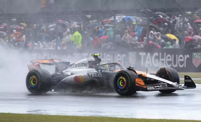 McLaren driver Lando Norris of Britain steers his car as it rains during the British Formula One Grand Prix race at the Silverstone racetrack in Silverstone, England, Sunday, July 6, 2025. (AP Photo/Darko Bandic)