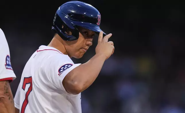 Boston Red Sox designated hitter Masataka Yoshida acknowledges fans after his single during the second inning of a baseball game against the Colorado Rockies at Fenway Park, Wednesday, July 9, 2025, in Boston. (AP Photo/Charles Krupa)