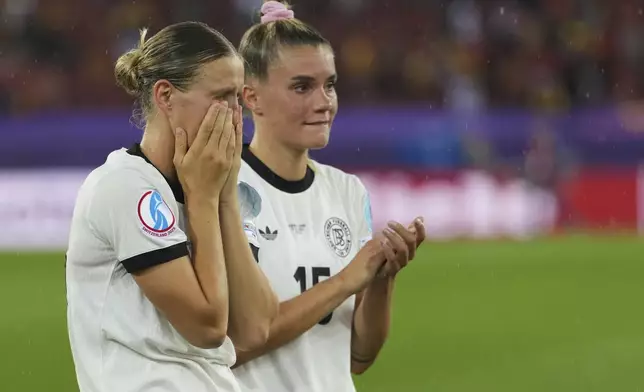 Germany's Klara Buehl, left, and Germany's Selina Cerci react after the Women's Euro 2025 semifinals soccer match between Germany and Spain at Stadion Letzigrund in Zurich, Switzerland, Wednesday, July 23, 2025. (AP Photo/Martin Meissner)