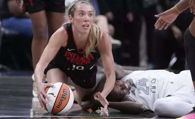 Indiana Fever's Lexie Hull (10) comes up with the ball against Las Vegas Aces' Jewell Loyd (24) during the first half of a WNBA basketball game, Thursday, July 24, 2025, in Indianapolis. (AP Photo/Darron Cummings)