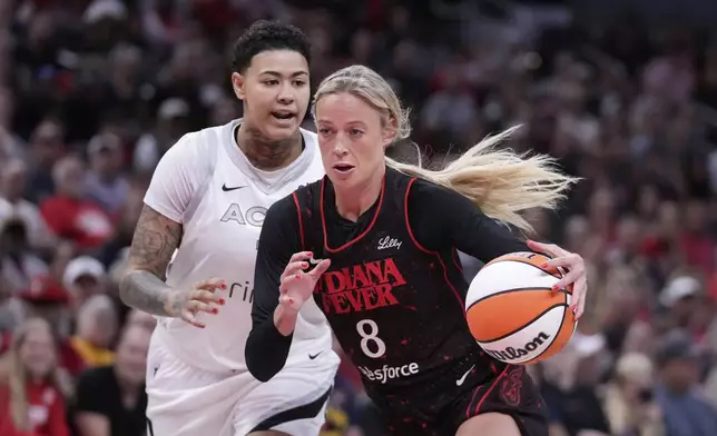Indiana Fever's Sophie Cunningham (8) goes to the basket against Las Vegas Aces' Kierstan Bell, left, during the first half of a WNBA basketball game, Thursday, July 24, 2025, in Indianapolis. (AP Photo/Darron Cummings)