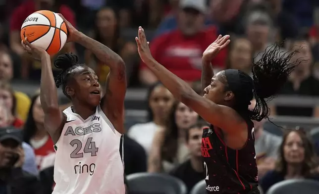 Las Vegas Aces' Jewell Loyd (24) shoots against Indiana Fever's Aari McDonald (2) during the first half of a WNBA basketball game, Thursday, July 24, 2025, in Indianapolis. (AP Photo/Darron Cummings)