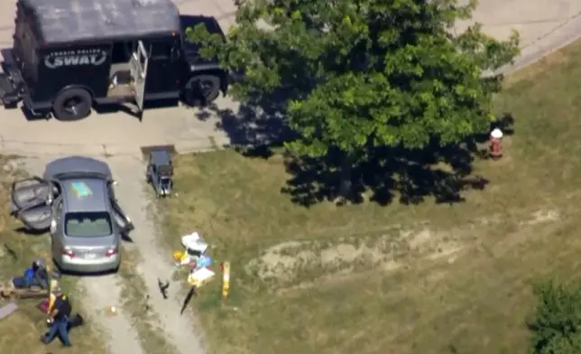This aerial image taken from video provided by WEWS shows police working at the scene of shooting after police officers were wounded and a man was killed in an exchange of gunfire early Wednesday afternoon, July 23, 2025, in an industrial area of Lorain, Ohio. (WEWS via AP)