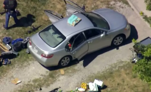 This aerial image taken from video provided by WEWS shows police working at the scene of shooting after police officers were wounded and a man was killed in an exchange of gunfire early Wednesday afternoon, July 23, 2025, in an industrial area of Lorain, Ohio. (WEWS via AP)