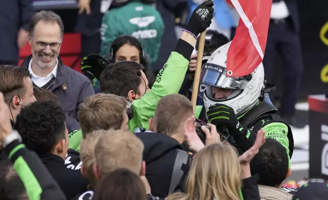 Kick Sauber driver Nico Hulkenberg of Germany, right wearing helmet, celebrates with his teammates for his 3rd position during the British Formula One Grand Prix race at the Silverstone racetrack in Silverstone, England, Sunday, July 6, 2025. (AP Photo/Darko Bandic)