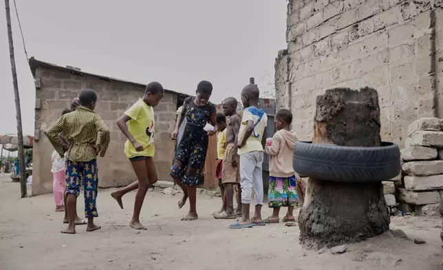 Cousins of late 15-year-old Jacques Koami Koutoglo, play outside their house in Lome, Togo, Monday, July 7, 2025. (AP Photo/Erick Kaglan)